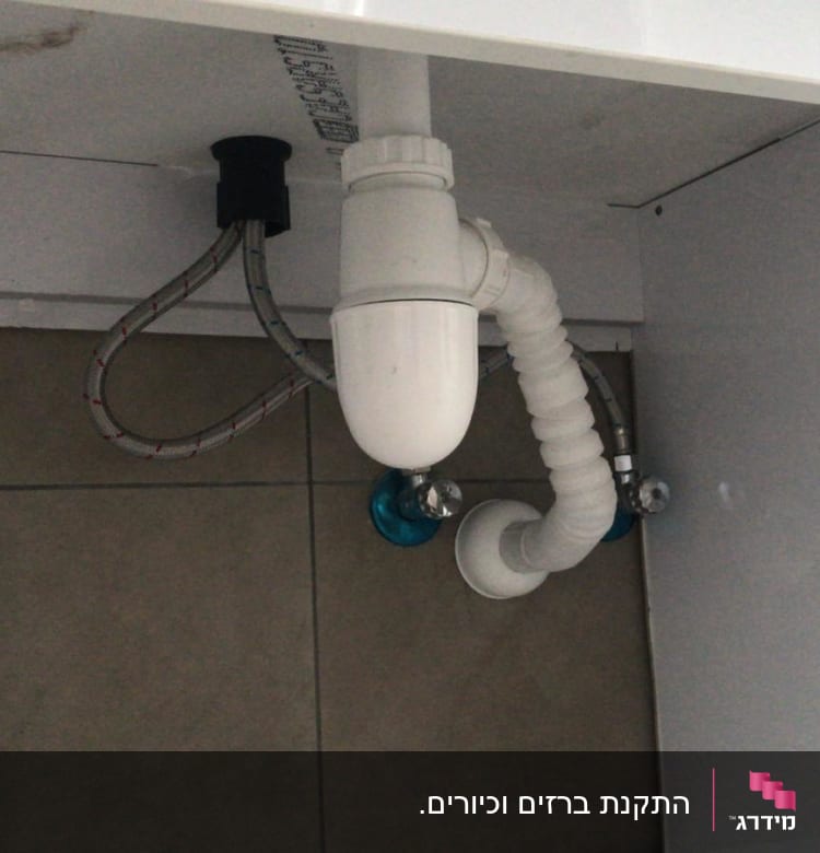 צנרת מתחת לכיור עם סיפון לבן